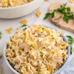 Creamy homemade tuna helper made with egg noodles, tender tuna, and cheesy sauce in a blue bowl.