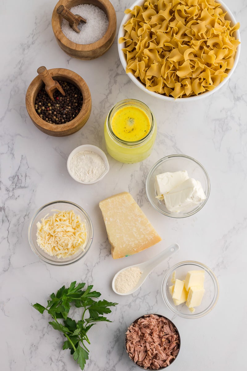 Ingredients for tuna helper in small bowls on kitchen counter in preparation for the recipe.