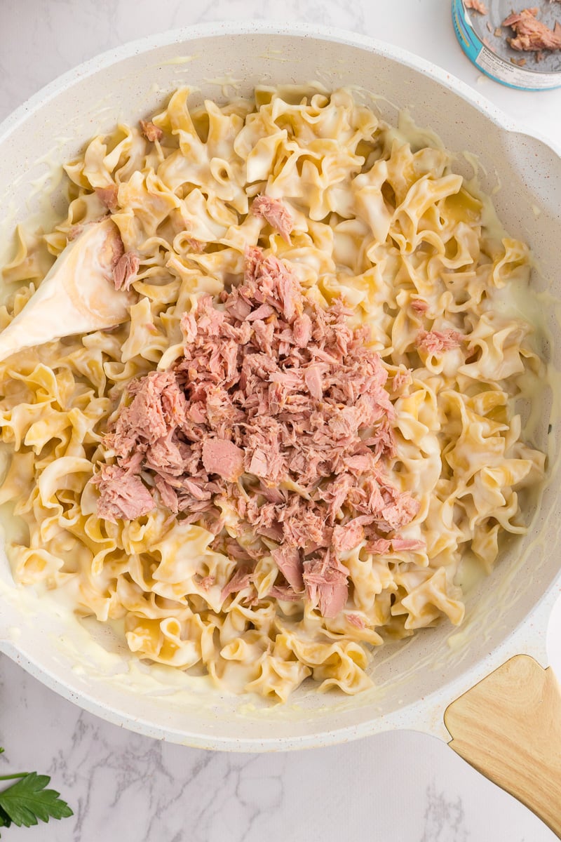 Tuna is added to pasta mixture.