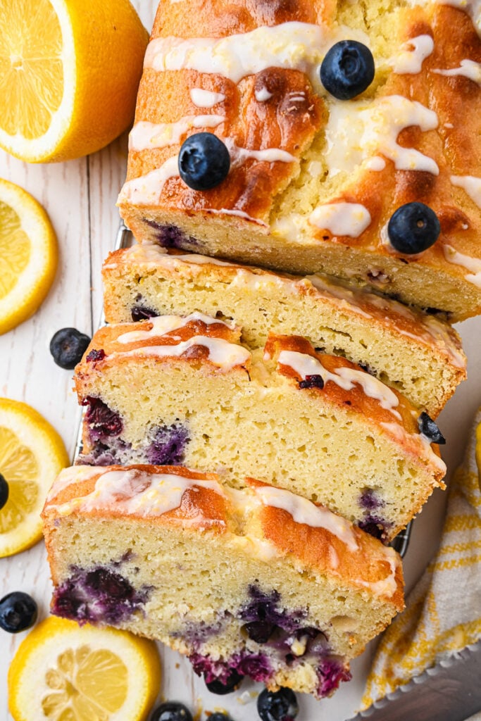 Blueberry lemon loaf sliced on a white plate.