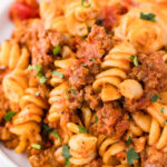 Bolognese pasta bake in a white bowl.