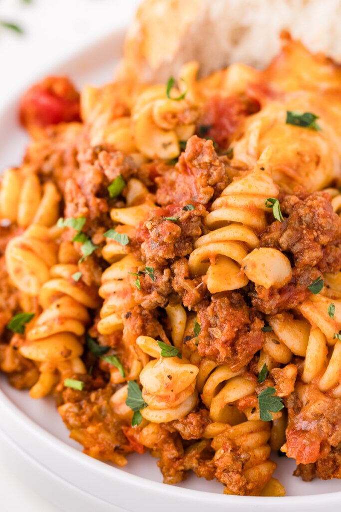Bolognese pasta bake in a white bowl.
