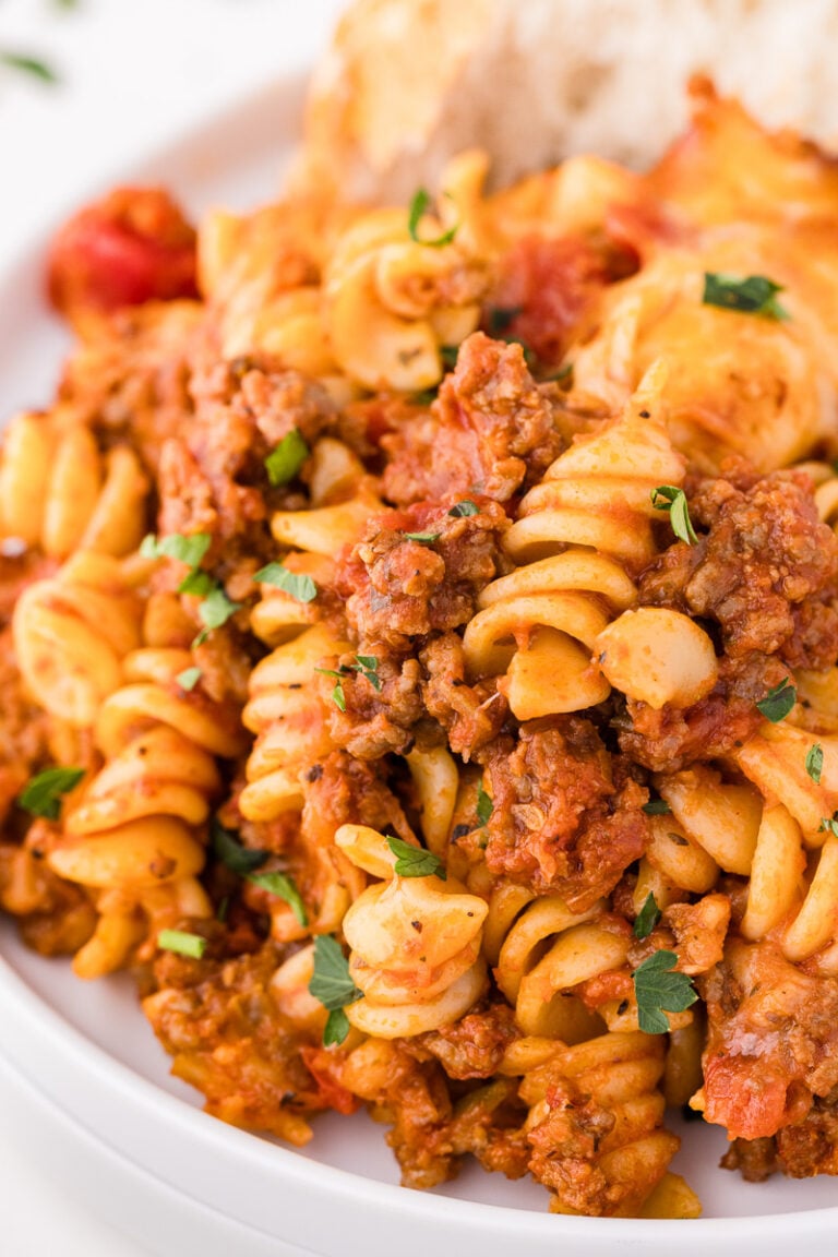 Bolognese pasta bake in a white bowl.