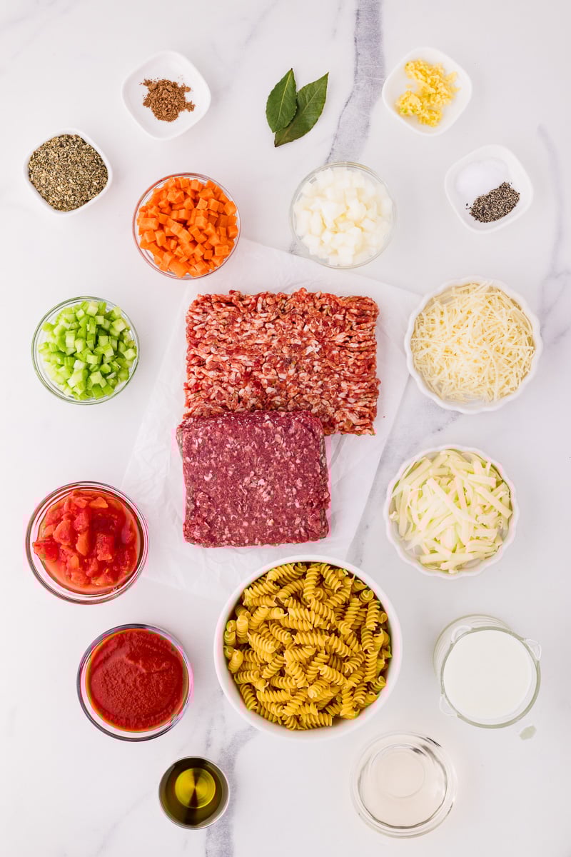 Ingredients for bolognese pasta bake laid out on kitchen counter in preparation for the recipe.