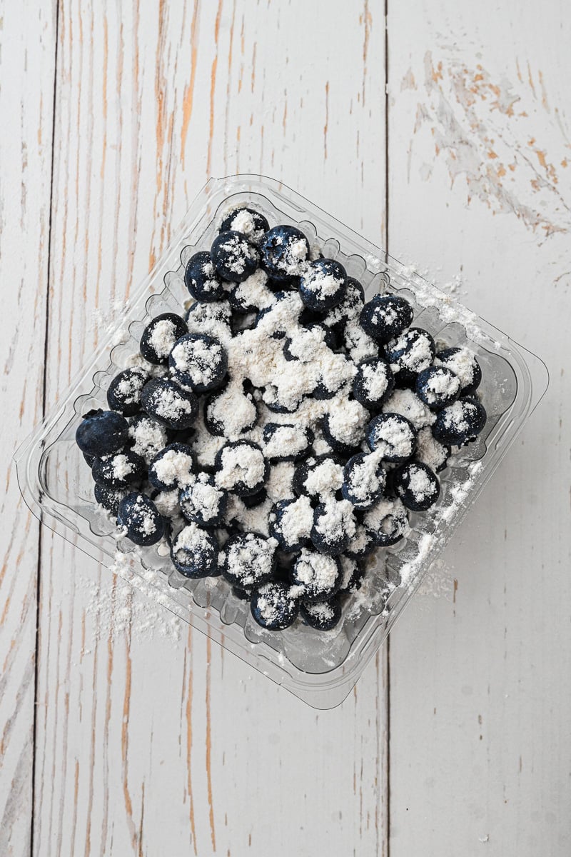 Bluberries are mixed with flour.