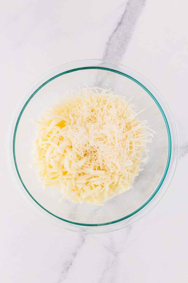 Mozzarella and parmesan cheese in mixing bowl.
