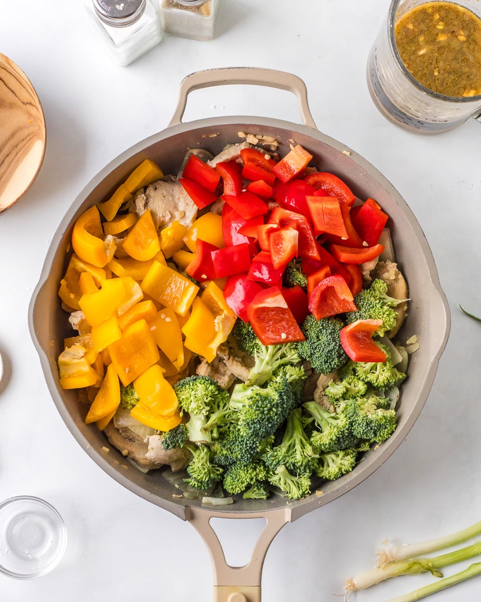 Peppers and broccoli are added to the stir fry.