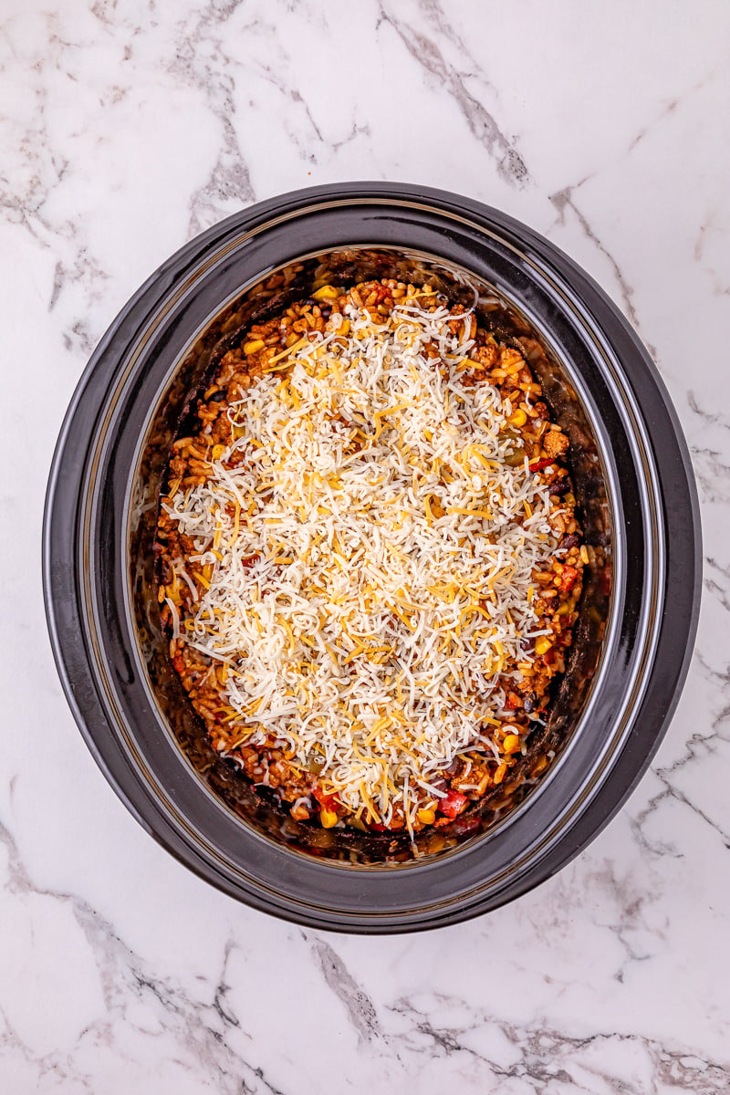 Cheese is sprinkled on top of the casserole.