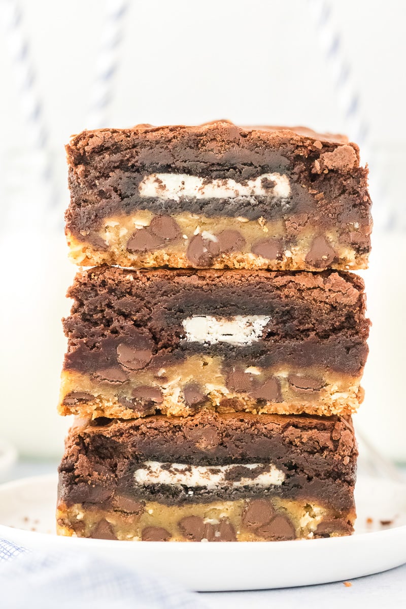 Brownies cut and stacked on a plate.