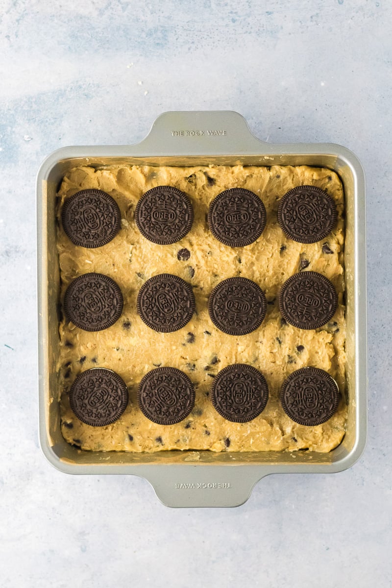 Oreo cookies are added in a single layer on top of the chocolate chip cookie dough.