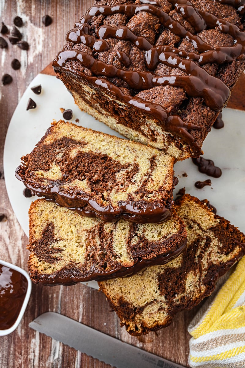 Chocolate swirl banana bread served on a plate.