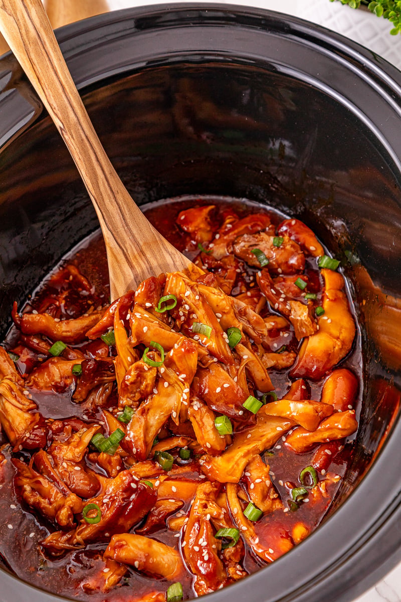 Crockpot honey garlic chicken in crockpot ready to be served.