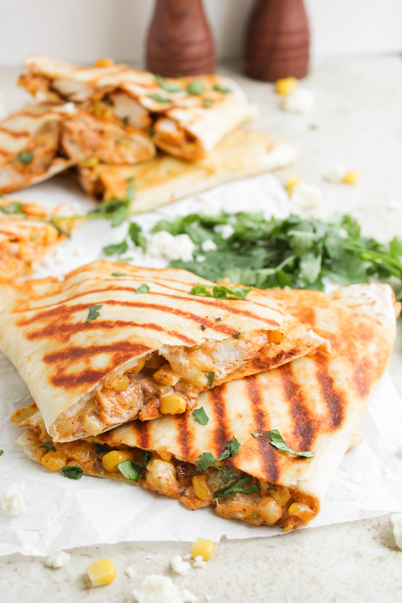 Street corn chicken quesadillas served on a white plate.