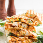 Street corn chicken quesadillas stacked on a plate.