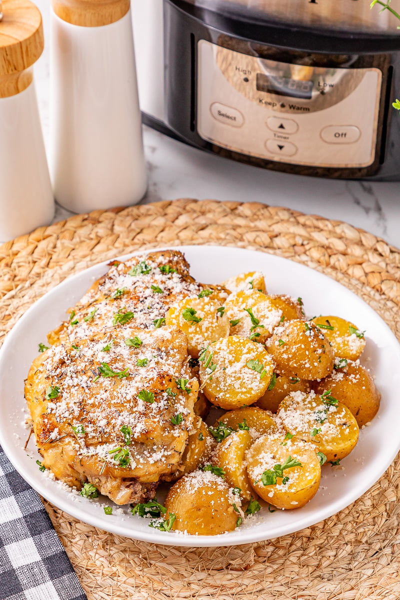 Crockpot Parmesan chicken & potatoes served on a plate.