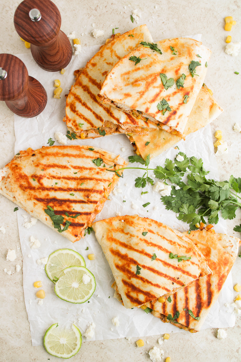 Sliced quesadillas on wooden board ready to be served.