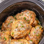Finished dish of crockpot garlic parmesan chicken thighs in crockpot.