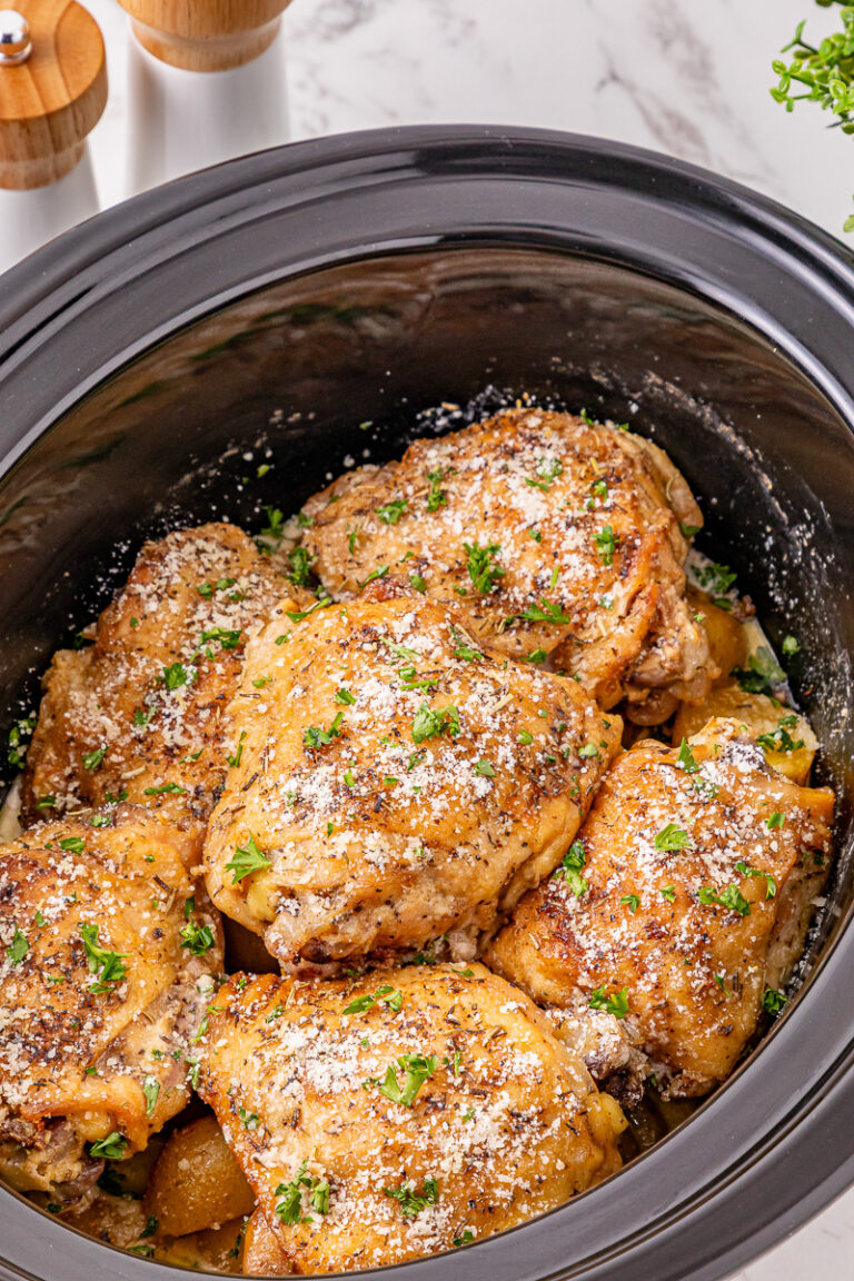 Finished dish of crockpot garlic parmesan chicken thighs in crockpot.
