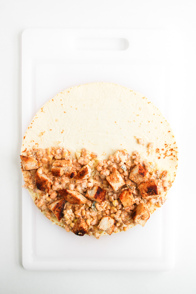 Street corn mixture and chicken are added to the half of the quesadilla.