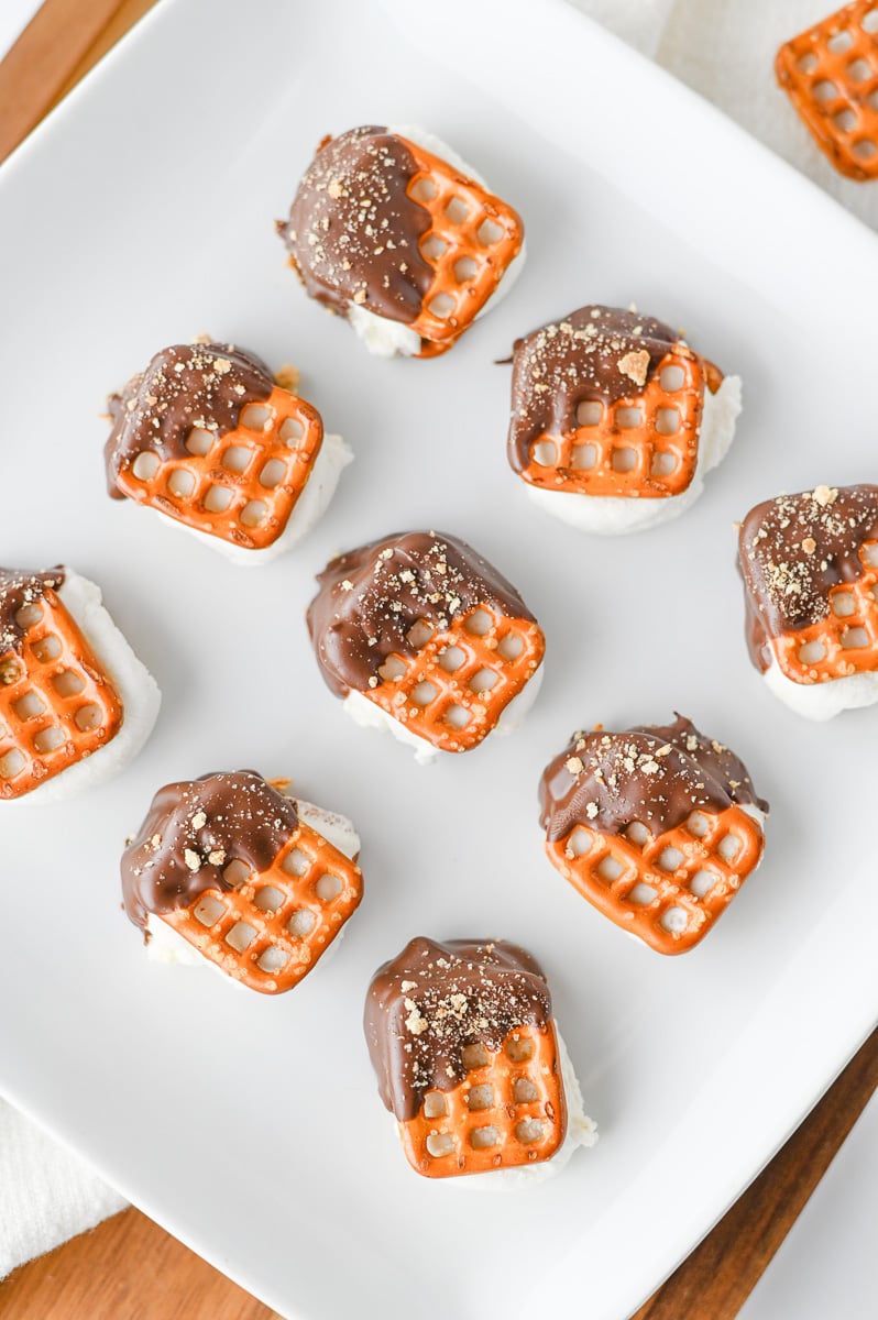 S'mores pretzel bites on a white plate.