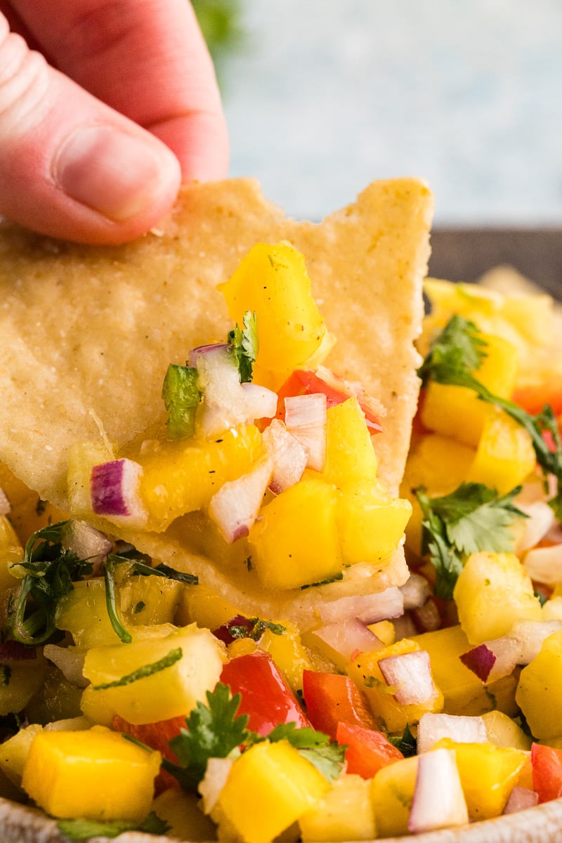 Mango salsa scooped up on a tortilla chip.