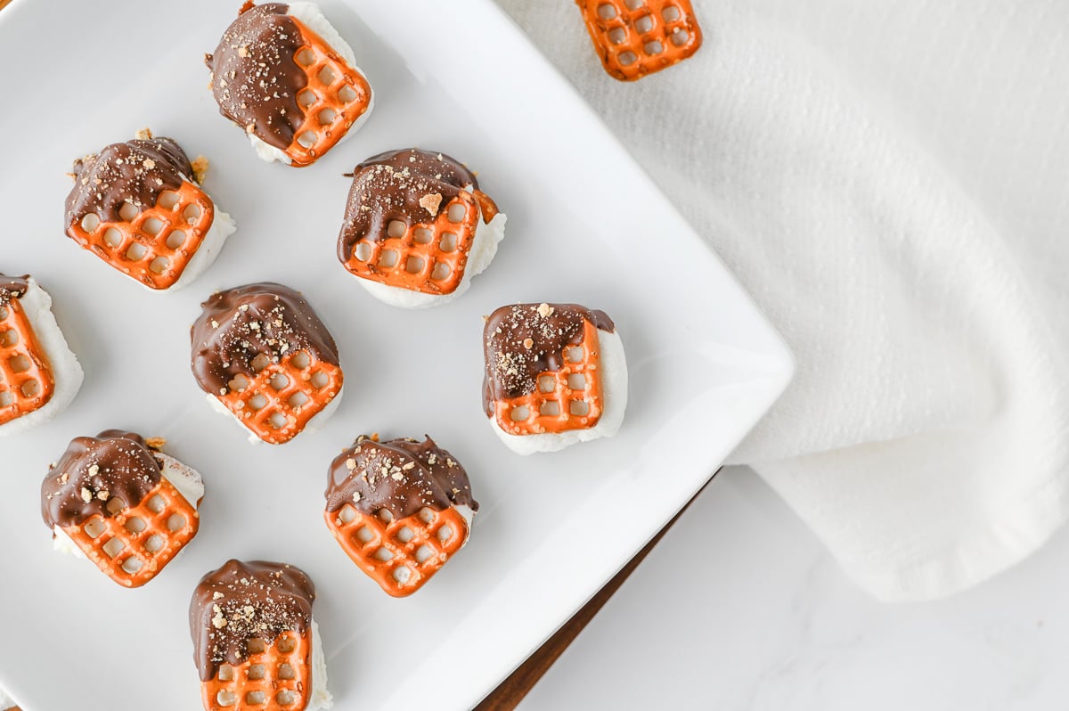 S'mores pretzel bites arranged on a plate, ready to serve.