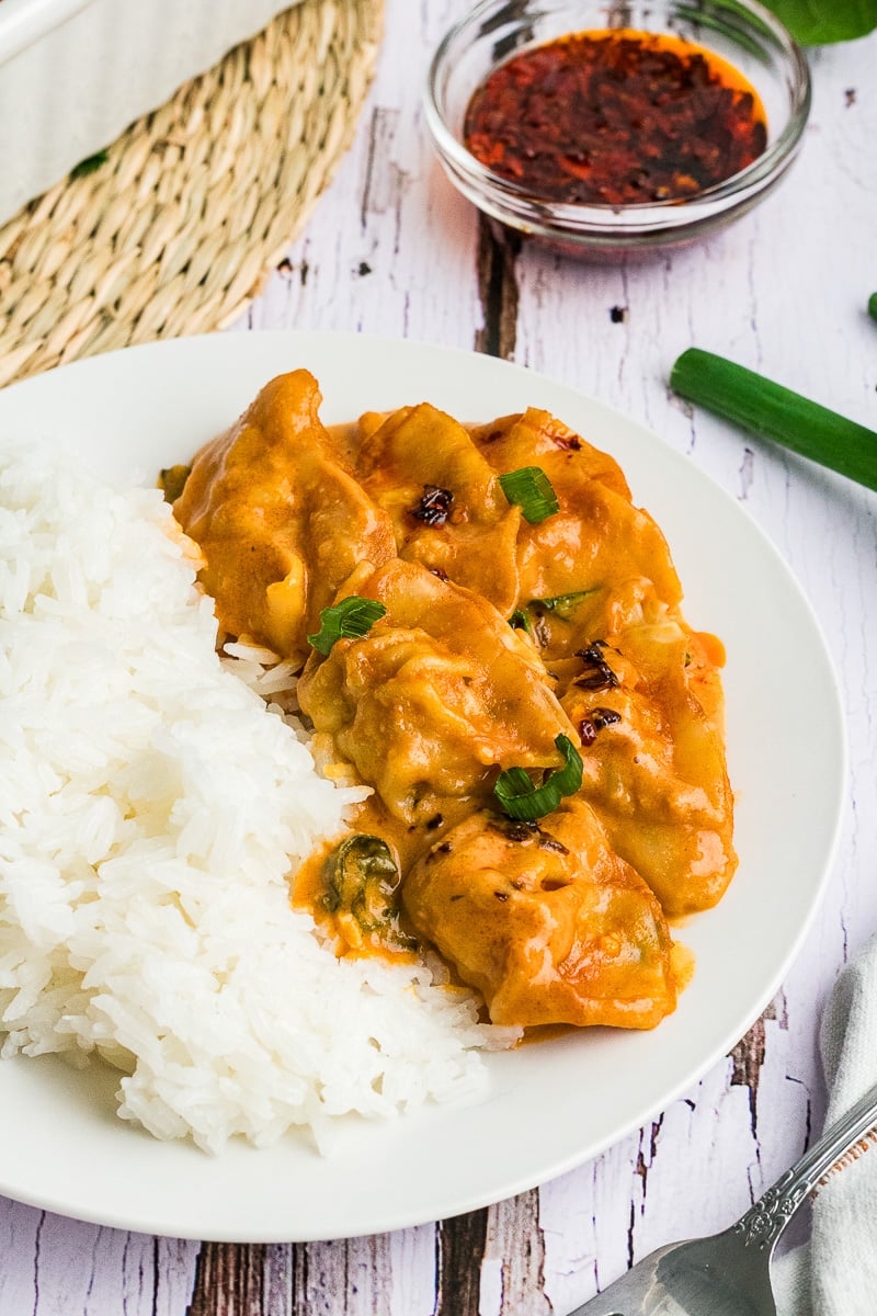 Dumpling bake served with rice on plate.