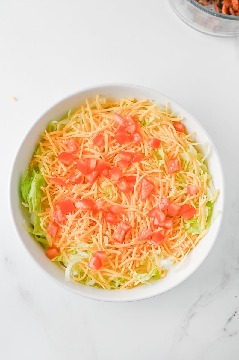 Tomatoes added to top of bowl.