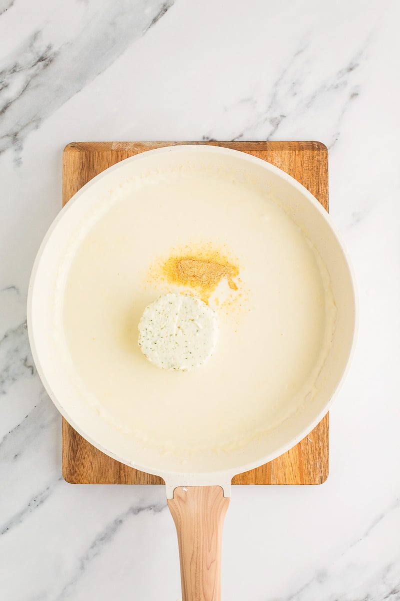 Boursin cheese is added to the skillet.