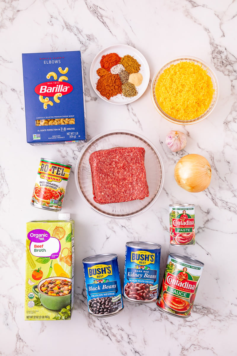 Ingredients for chili mac in small bowls on kitchen counter.