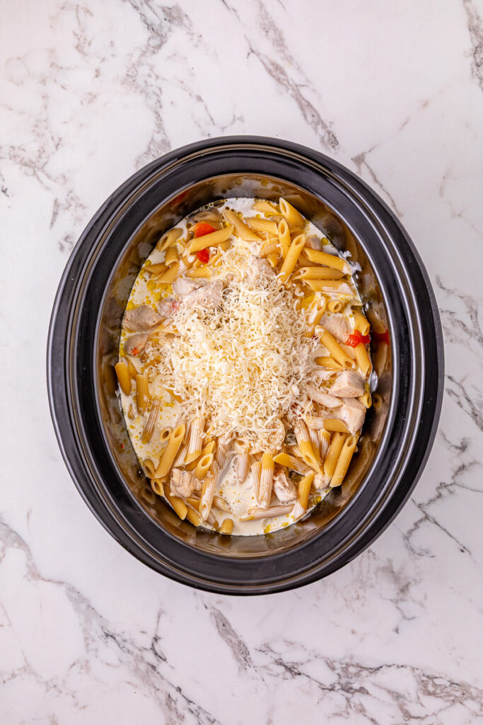 Cheese is added to the top of the pasta mixture.