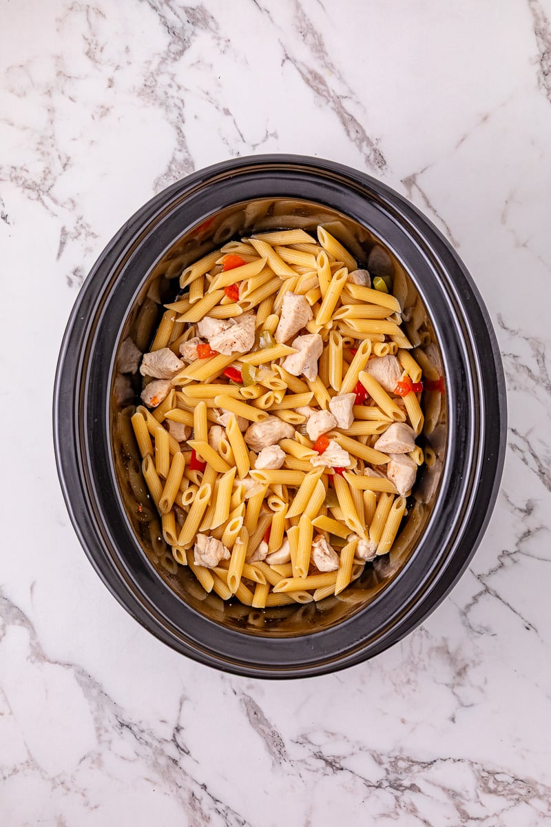 Penne pasta is added to the crockpot.