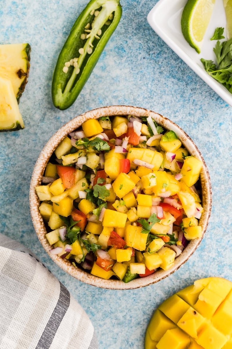 Mango pineapple salsa served in a white bowl.