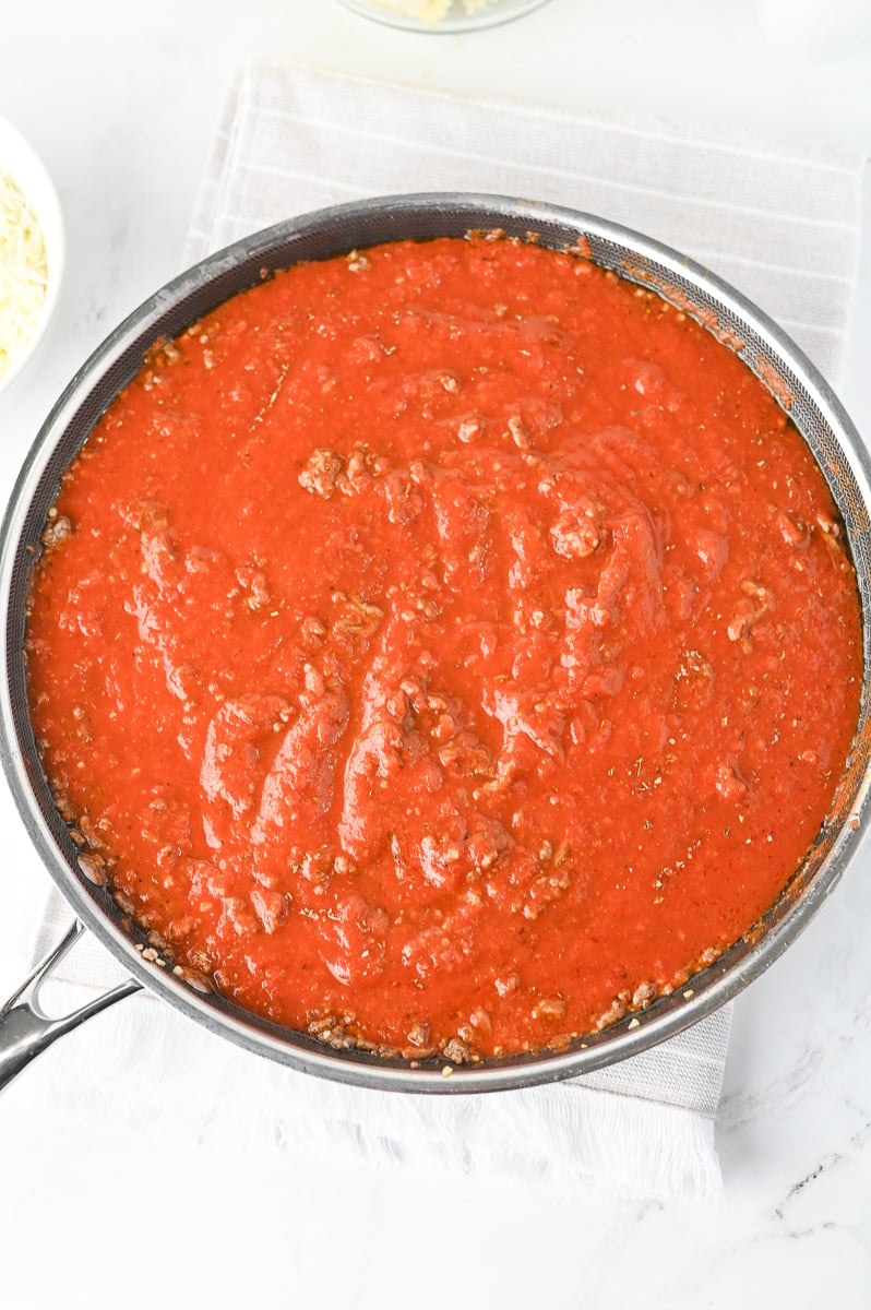 Pasta sauce and Italian seasoning in skillet added to the ground beef.
