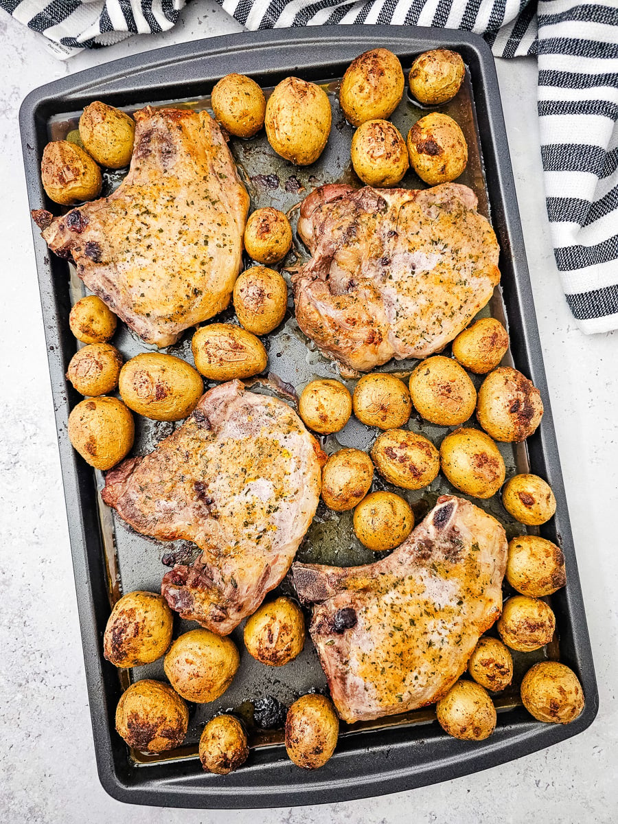 Sheet pan pork chop and potatoes finished dish, ready to be served.