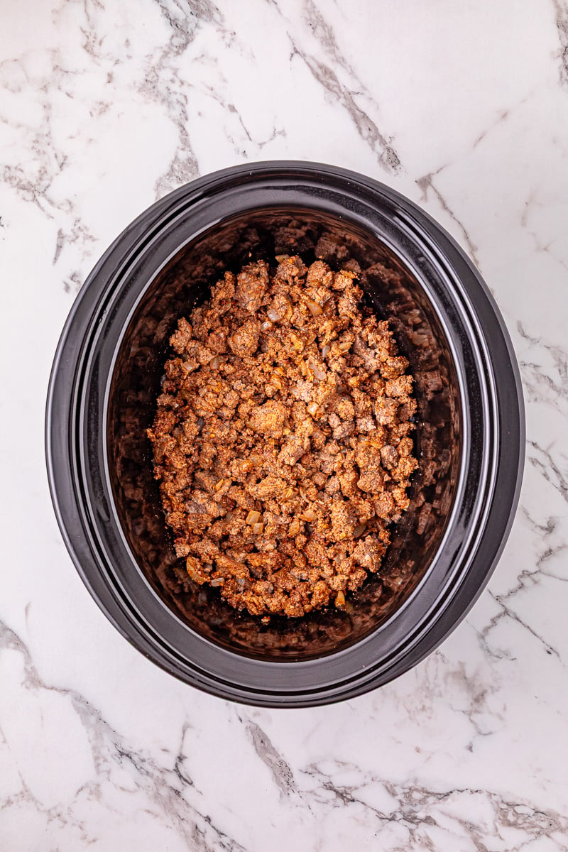 Ground beef mixture is added to crockpot.