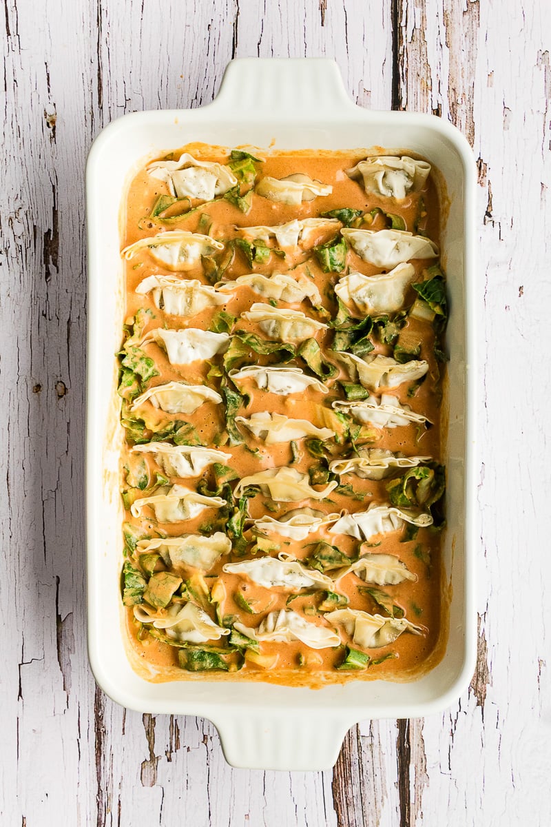 Dumplings are layered in baking dish.