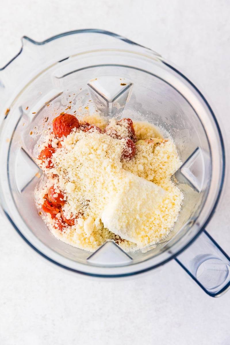 Cream cheese and Parmesan cheese are added to the tomato mixture in food processor.