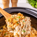 Crockpot Ritz cracker chicken scooped up on a spoon.