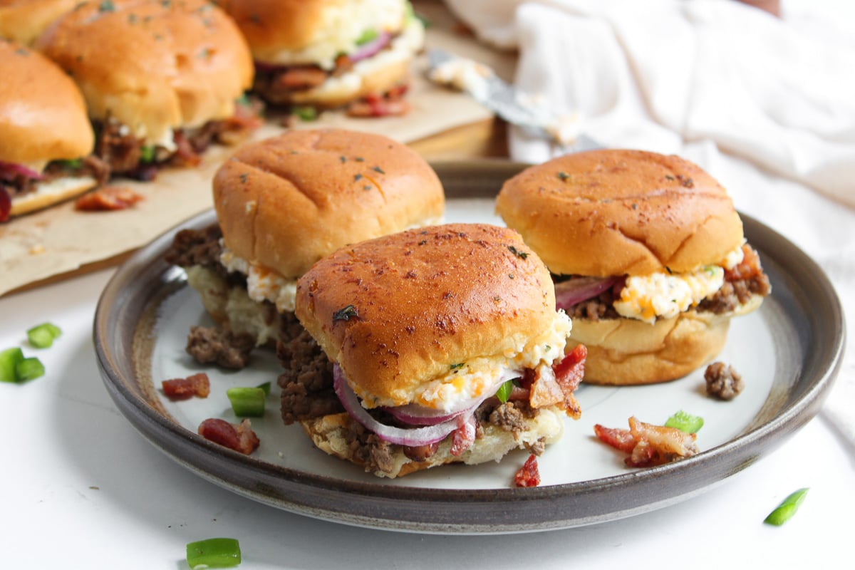 Finished dish of sliders on a plate.