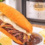 Crockpot French dip sandwiches dipped into au jus gravy.
