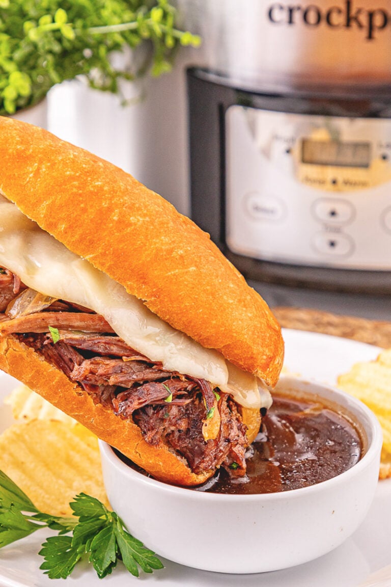 Crockpot French dip sandwiches dipped into au jus gravy.