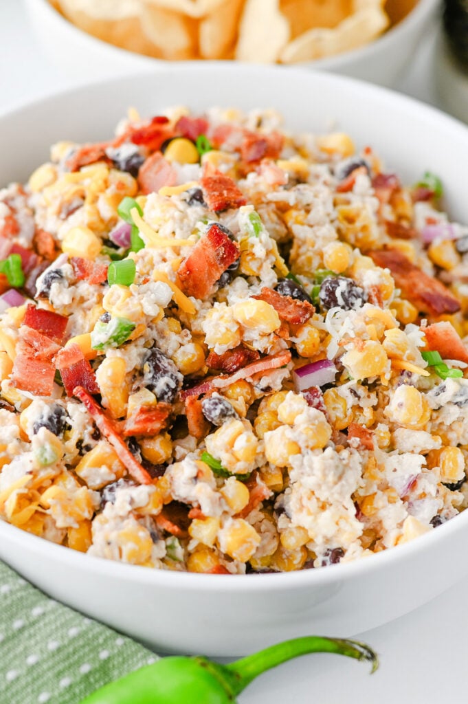 Cwoboy corn dip in a white bowl ready to be3 served for a party.
