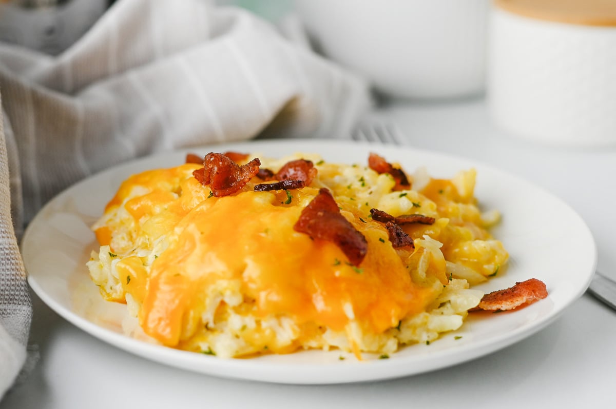 Crockpot hashbrown casserole served on a white plate.