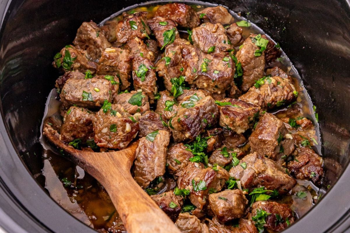 Garlic butter steak bites finished dish in slow cooker ready to be served.