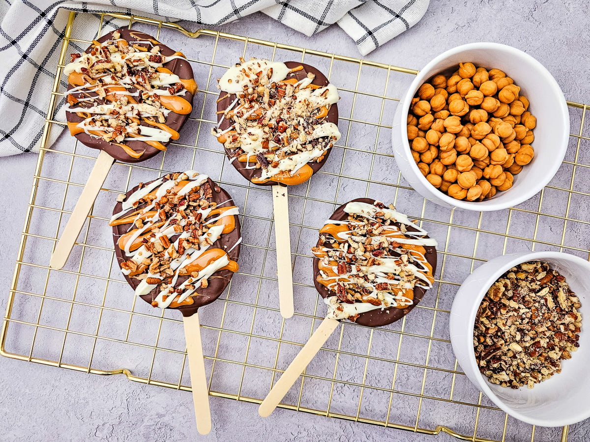Chocolate caramel apple slices on wire cooling rack.