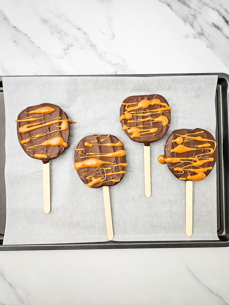 Caramel is drizzled over apple slices.