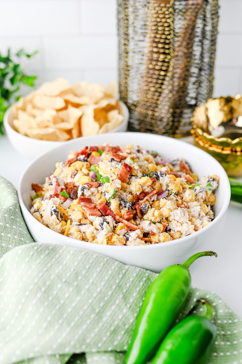 Cowboy corn dip served in a bowl with crackers on the side.