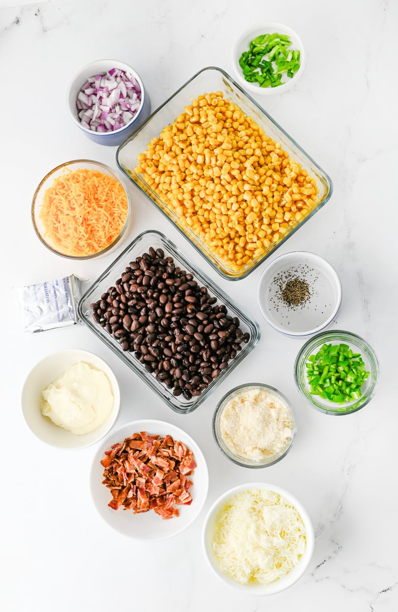 Ingredients for cowboy corn dip in small bowls on counter ready for the recipe.