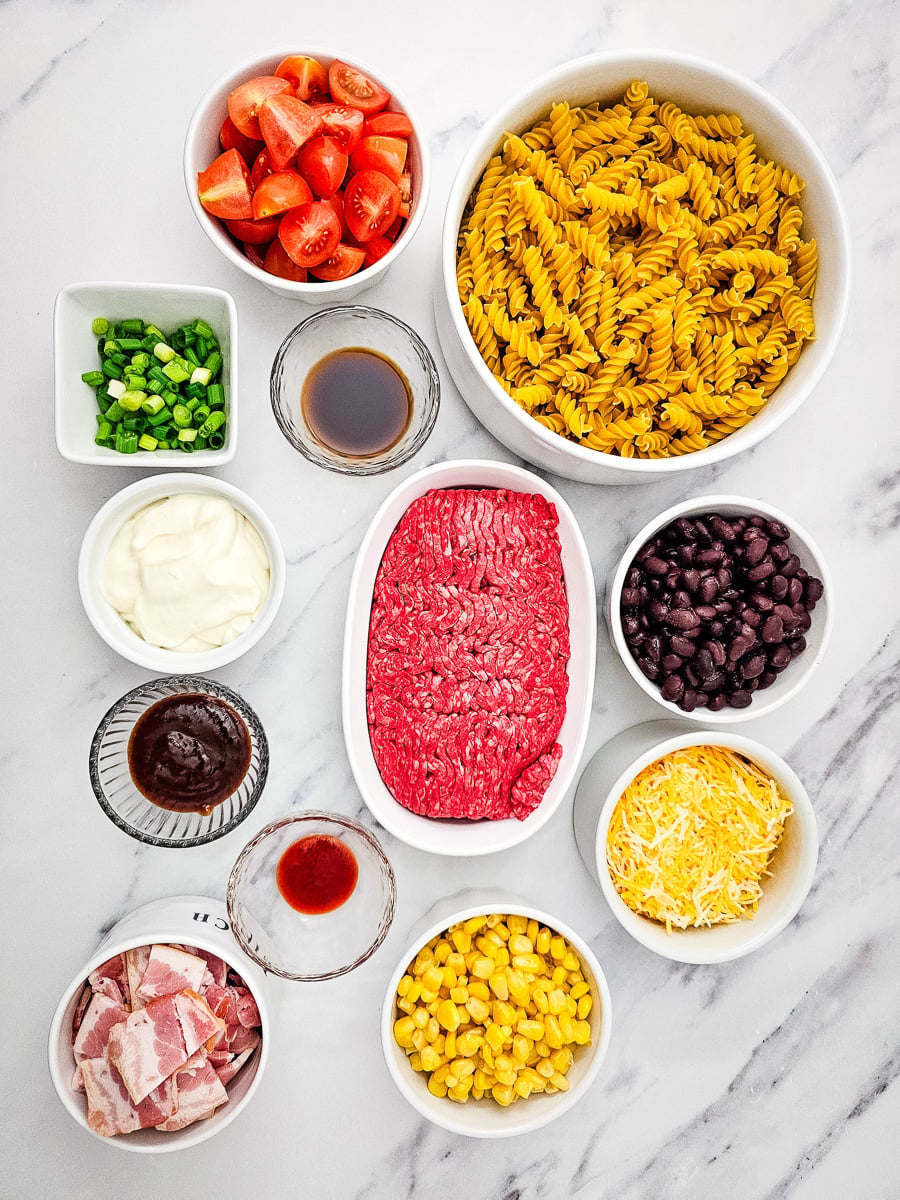 Cowboy pasta salad ingredients in small bowl on kitchen counter.